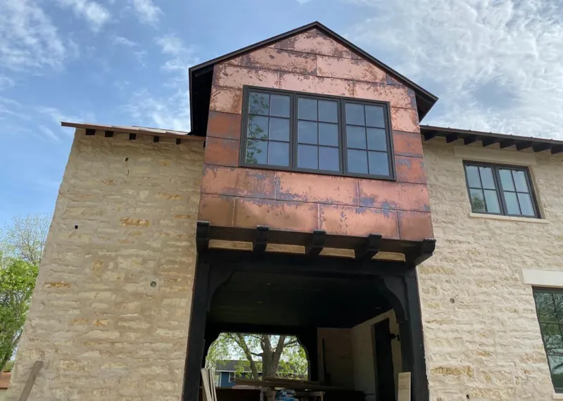 Copper metal panel facade on a stone building for Skylight Installation in Fenton